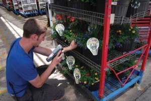 At Metrolina Greenhouses, a handheld scanner reads the bar code on each cart, along with the UPC for each unique item on each cart shelf. Once the items are scanned, a label is printed with a barcoded list of the items and quantities on the cart.   Photo by Amanda Tomaini, Practical Software Solutions