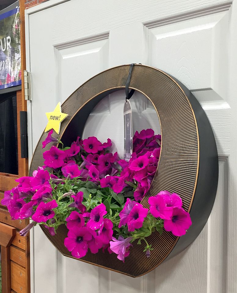 The Stella Wreath Hanger allows homeowners to switch out plants from season to season, from holiday evergreens to summer petunias. 