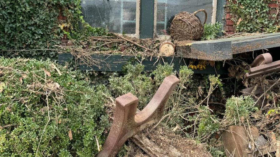 Damage in the aftermath of Hurricane Helene at the Gardener's Cottage garden shop in Asheville, NC