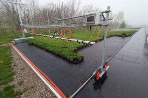 The AdeptAg Single Rail Ground Boom for outdoor bay irrigation.